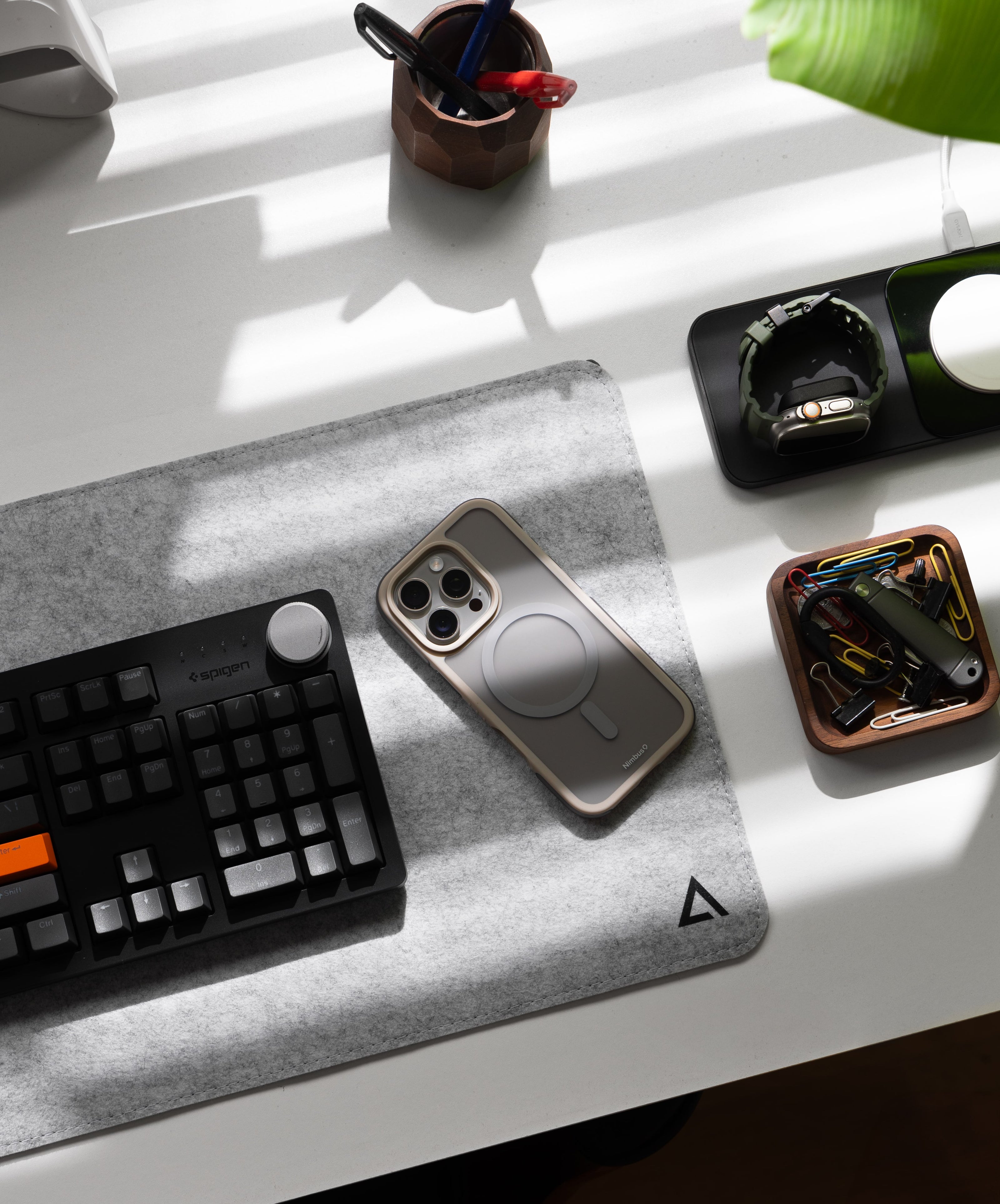 The Nimbus9 Summit MagSafe case in Gold elegantly placed on a modern desk setup, showcasing premium protection with a sleek, sophisticated look. Designed for iPhone users who appreciate durability and refined aesthetics, this case blends seamlessly with any workspace.