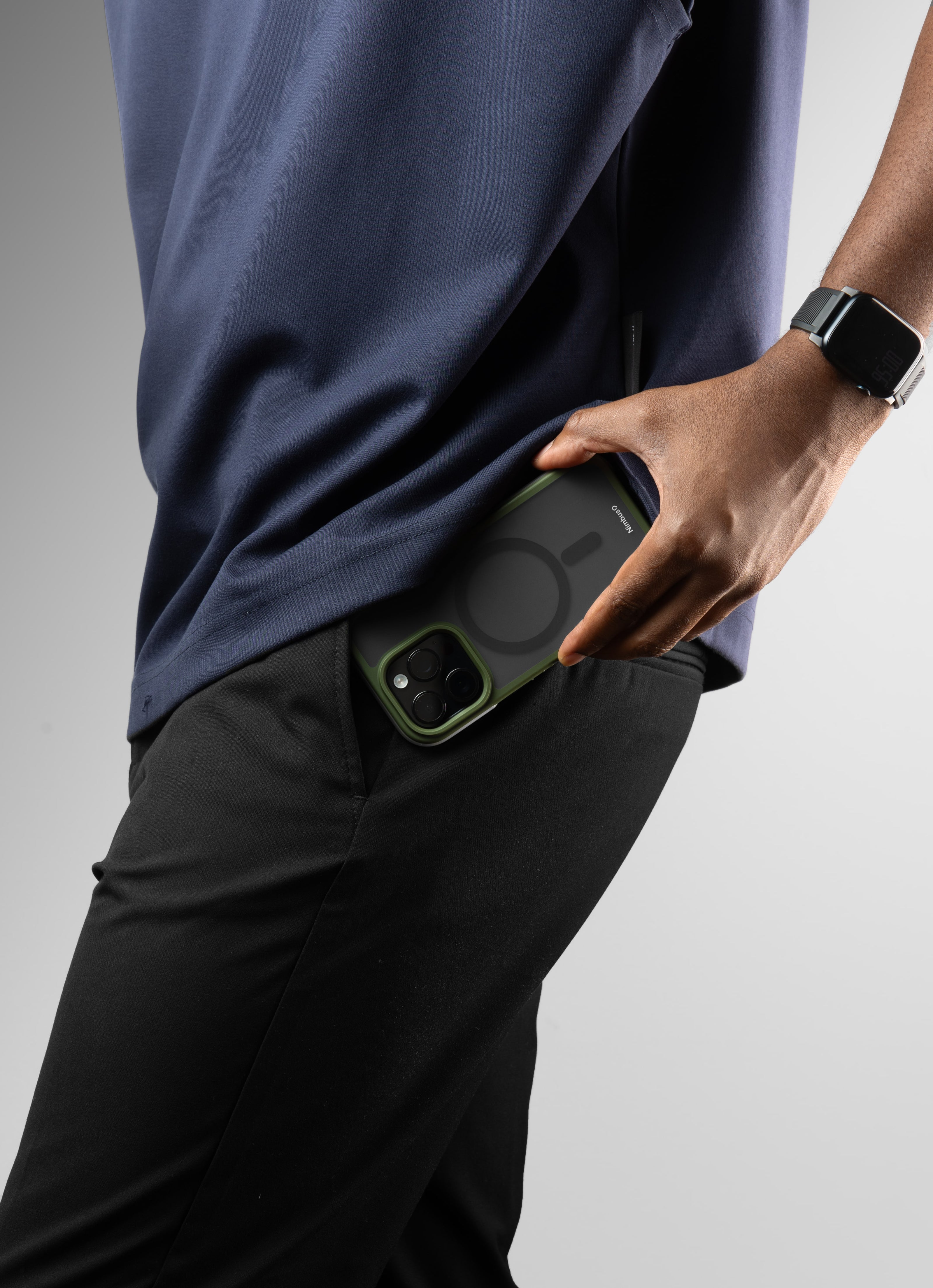 A Nimbus9 Summit MagSafe case in Green slipping into a pocket, demonstrating its slim yet durable design. Perfect for on-the-go professionals and active lifestyles, the Summit case provides rugged protection without bulk.