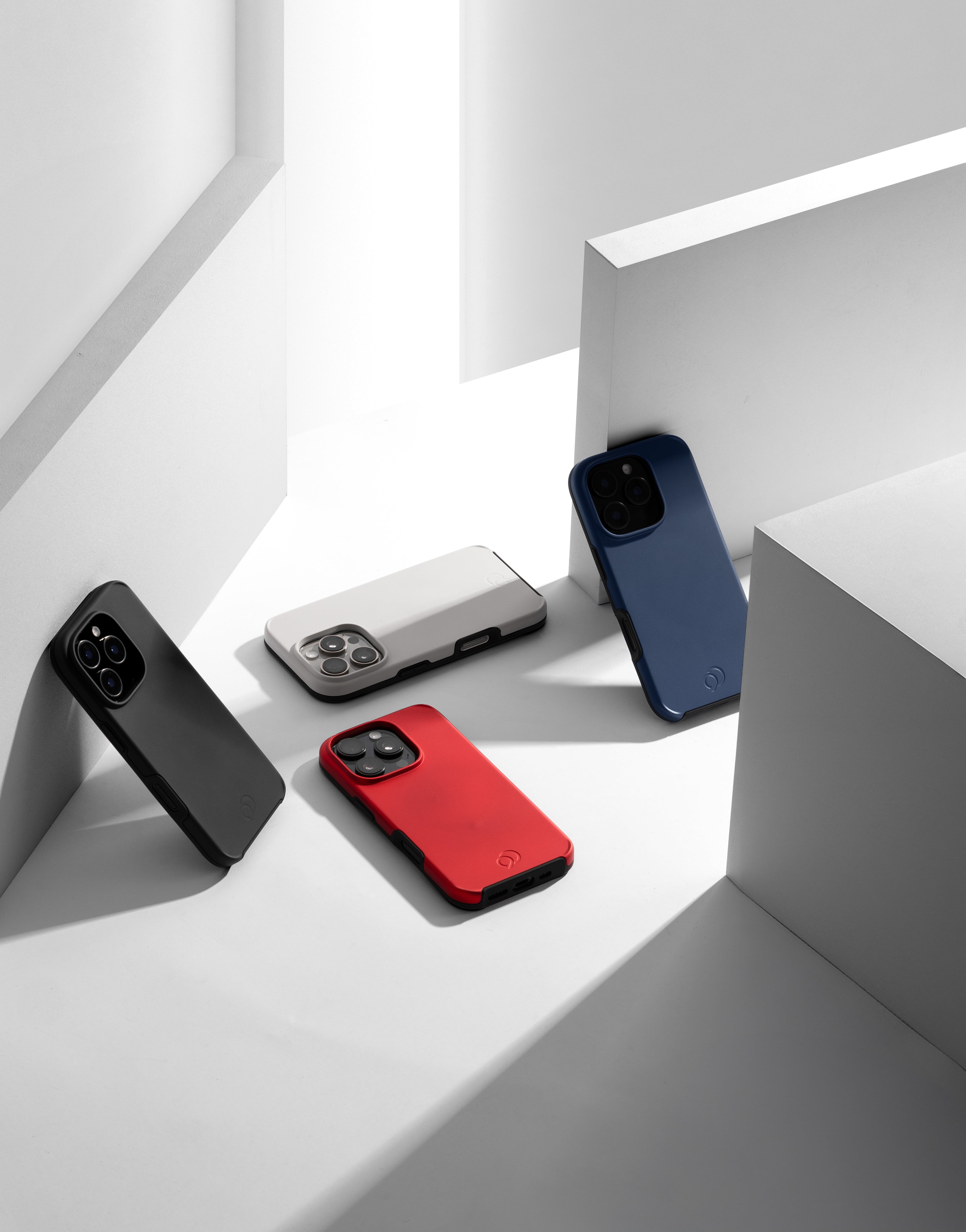 A collection of Nimbus9 Cirrus 2 cases in black, white, red, and blue, showcasing sleek design and durable protection for iPhone. Perfect for everyday use with a soft-touch finish.