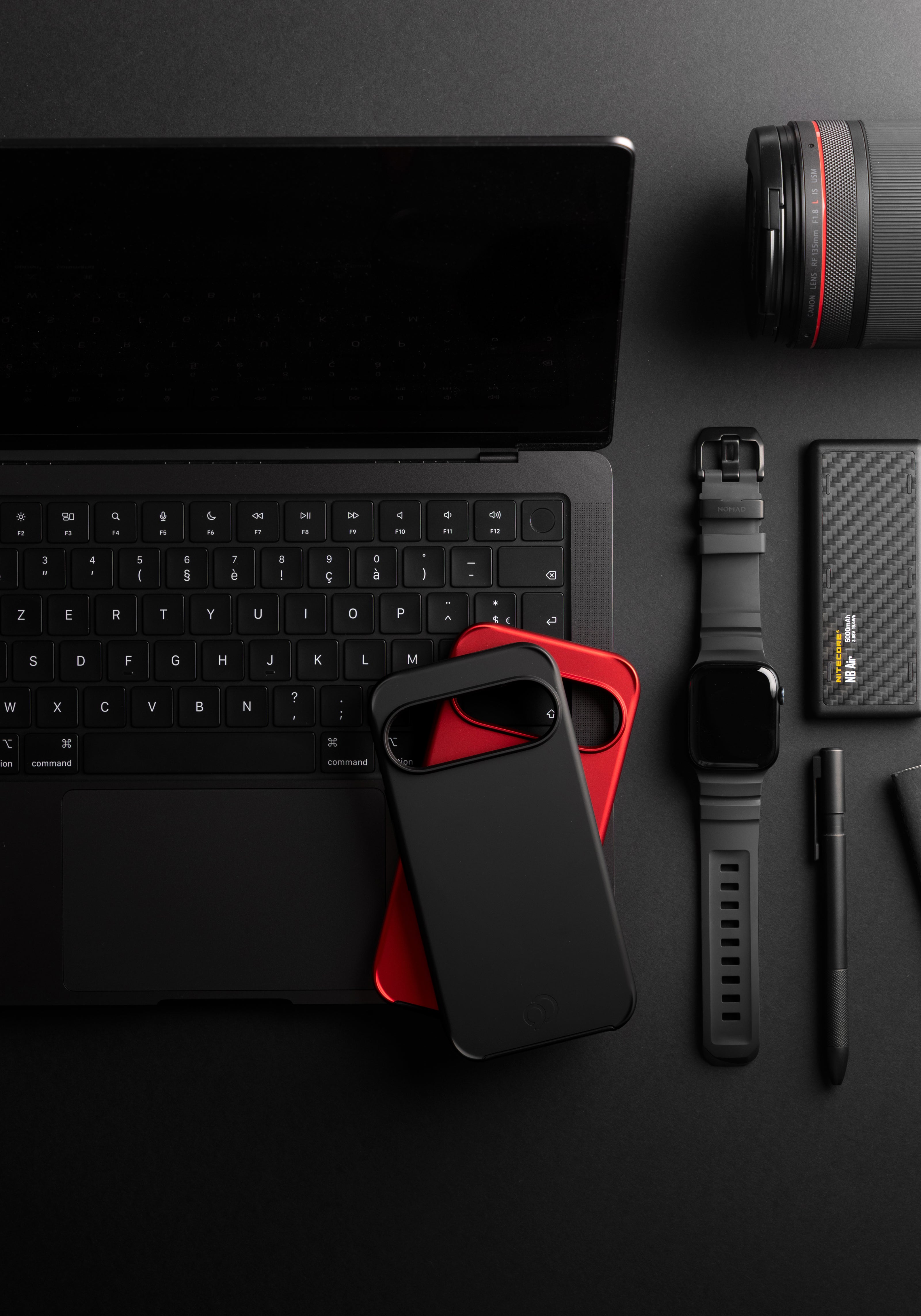 Nimbus9 Cirrus 3 case for Google Pixel in matte black, stacked on a red case in a black desk setup.
