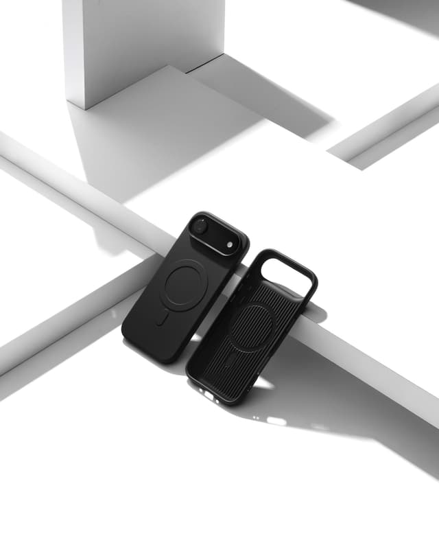 Two Nimbus9 Alto 2 cases in Black on a white geometric studio set — one fitted on a phone, one propped empty with its MagSafe ring showing