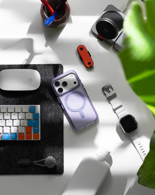 Nimbus9 Phantom 3 clear case with lavender tint, iPhone in sunlit desk flat-lay