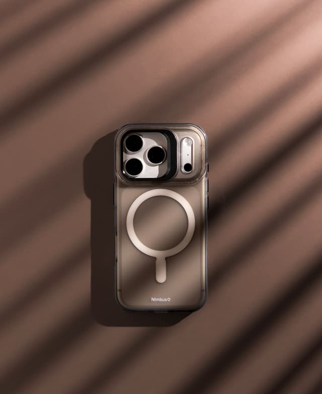 Stratus 2 case flat on a warm tan backdrop under window-blind shadow stripes, magnet ring visible