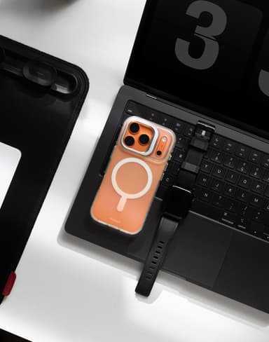 Stratus 2 case on a phone on a laptop keyboard beside a smartwatch