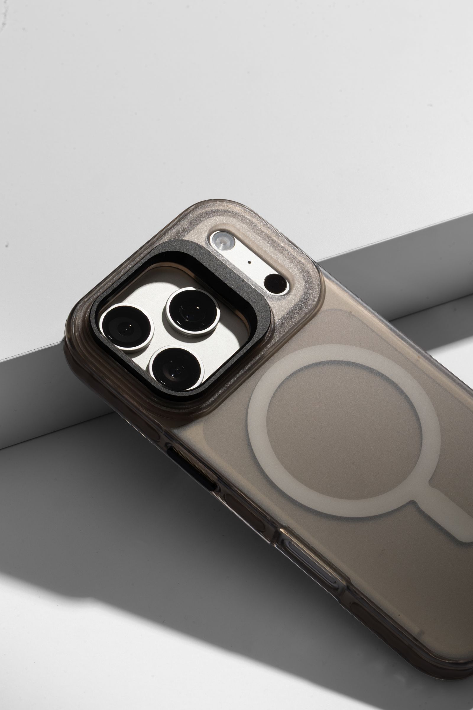 Stratus 2 camera cutout and magnet ring, the case propped at an angle with a hard shadow