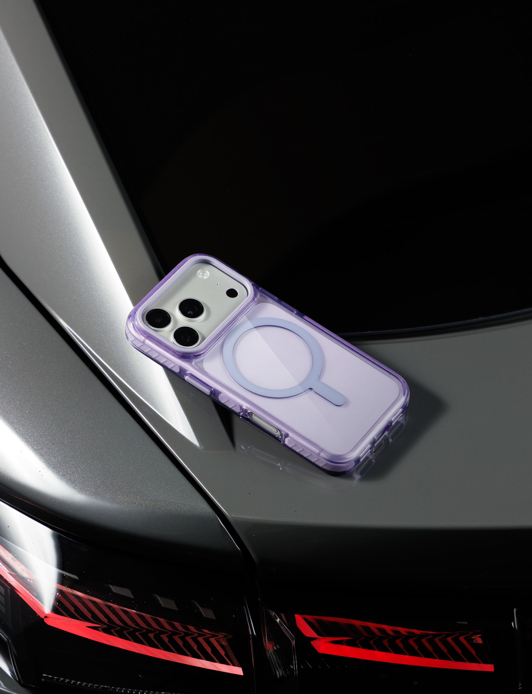 Nimbus9 Phantom 3 case on a car hood at dusk, taillights glowing behind it